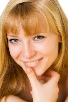 Portrait of the smiling young woman. The beautiful face close up.