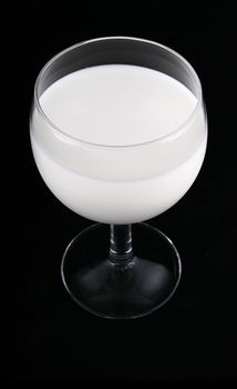 glass of milk isolated on black background