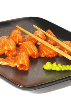 slice of salmon sushi with wasabi sauce