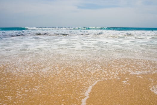 Paradise beach with blue sky and water and white sand.