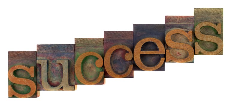 success or growth concept - old letterpress wooden type blocks, stained by colorful inks,  isolated on white