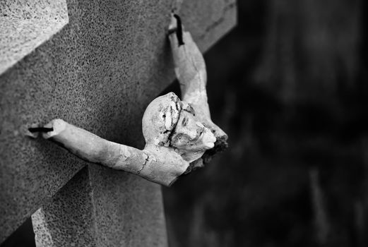 Broken figure of jesus Christ on a grave marker