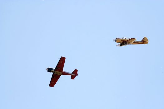 Two propeller-driven airplanes on clear sky  background 2