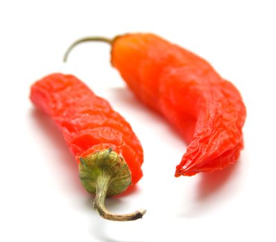 Red peppers on a white background. Isolation, shallow DOF