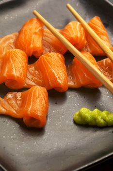 slice of salmon sushi with wasabi sauce