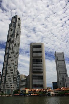 A view of Singapore river. Tall and Modern buildings behind the pre-war houses at Clark Quay.