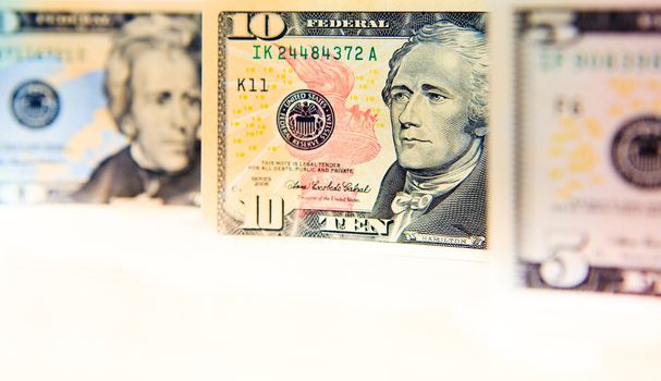 US banknotes on a fan of high-denomination european euro notes