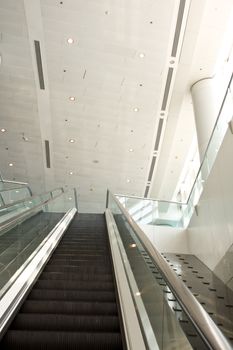 It is a close up with escalator in a building.