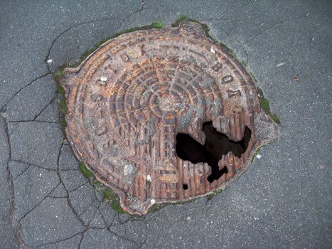 Black Hole in rusty iron hatch cover