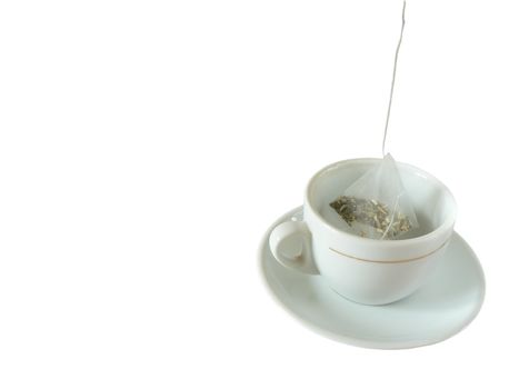 Cup and tea bag isolated on white background