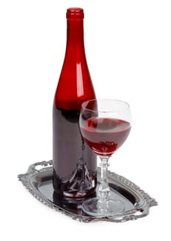 Red wine bottle and glass on a metal tray