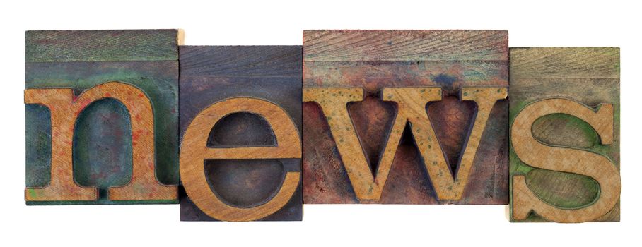 the word news in vintage wooden letterpress type, lower case, stained by colorful inks, isolated on white