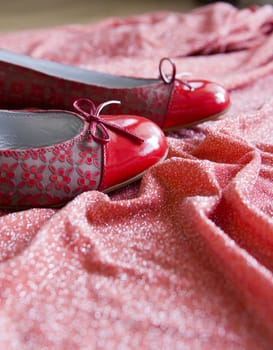 pair of red shoes on a red material