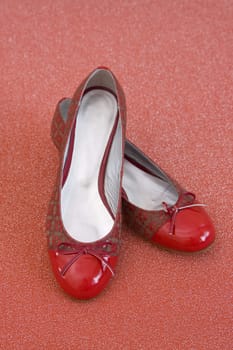 pair of red shoes on red material