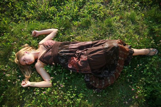 Young woman lying on the grass