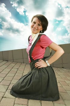 Stylish woman kneeling smiling at camera.