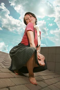 Barefooted girl with feet on concrete slabs