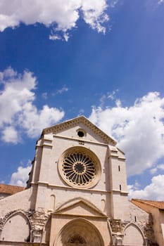 Church against a blue cloudly sky in Italy