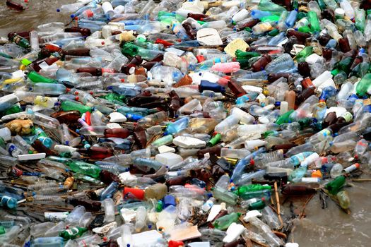 Plastic waste of bottles floating on water