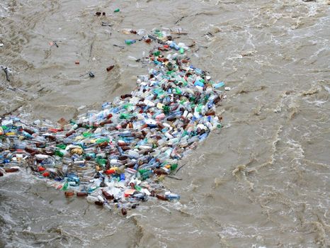 Plastic waste of bottles floating on river.