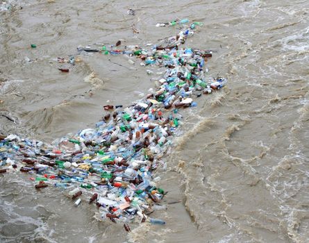 Plastic waste of bottles floating on river.