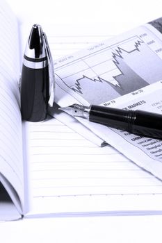 notebook  newspaper and fountain pen,blue filter  on white background