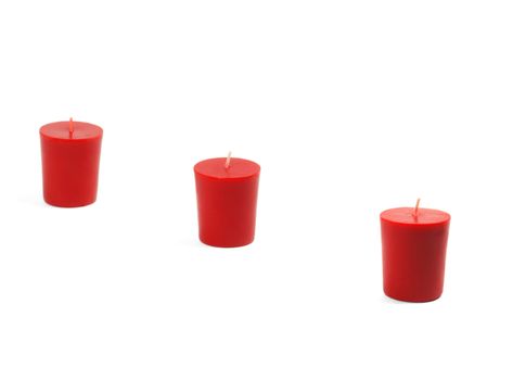 three red candles isolated on white background