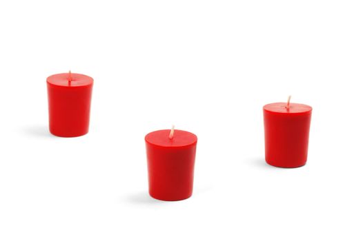 three red candles isolated on white background