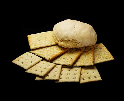 fresh bread and crackers on black background