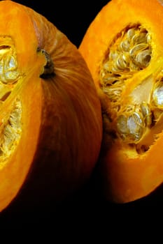 fresh deep vivid yellow pumkin  on black background