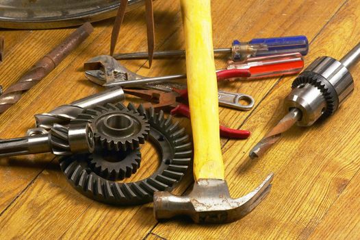 bounch of rusty tools and gears on the wood floor