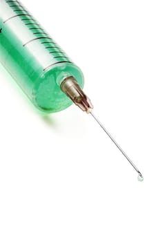 syringe filled with green liquid over white background