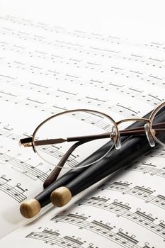 music charts ,with drums stick and glasses on top
