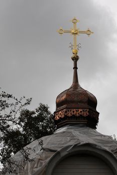 Old church. Renovation. Copper dom and golden cross.