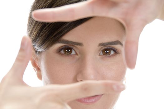 beautiful woman showing framing hand gesture on an isolated white background