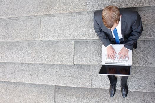 Business man sitting on stairs outdoor