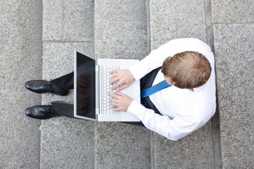 Business man sitting on stairs outdoor