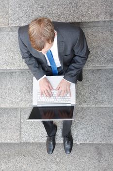 Business man sitting on stairs outdoor