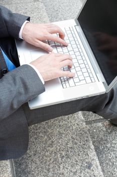 Business man sitting on stairs outdoor