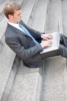 Business man sitting on stairs outdoor