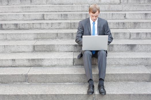 Business man sitting on stairs outdoor