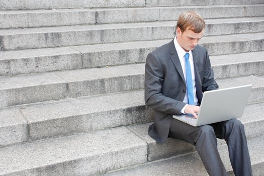 Business man sitting on stairs outdoor