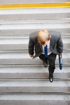 A business man walking down some steps