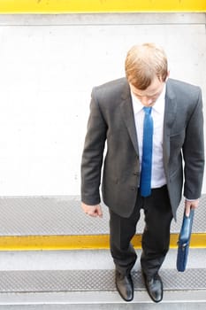 A business man walking down some steps