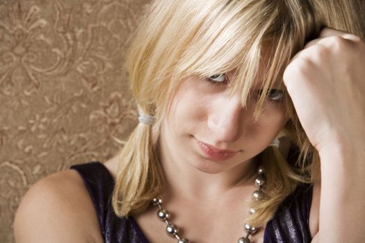 Pretty young girl with hand on her head