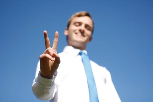 A business man showing the V sign