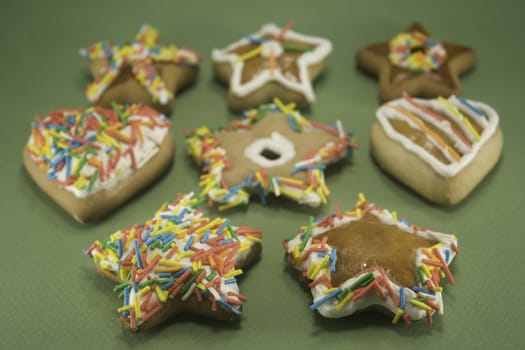 Decorated gingerbread cookies on green paper