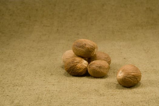 Whole nutmeg fruits on burlap