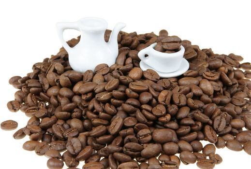 Stack of coffe beans with miniature coffee service