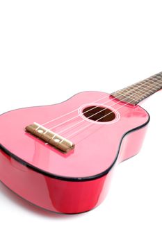A small pink guitar isolated on white